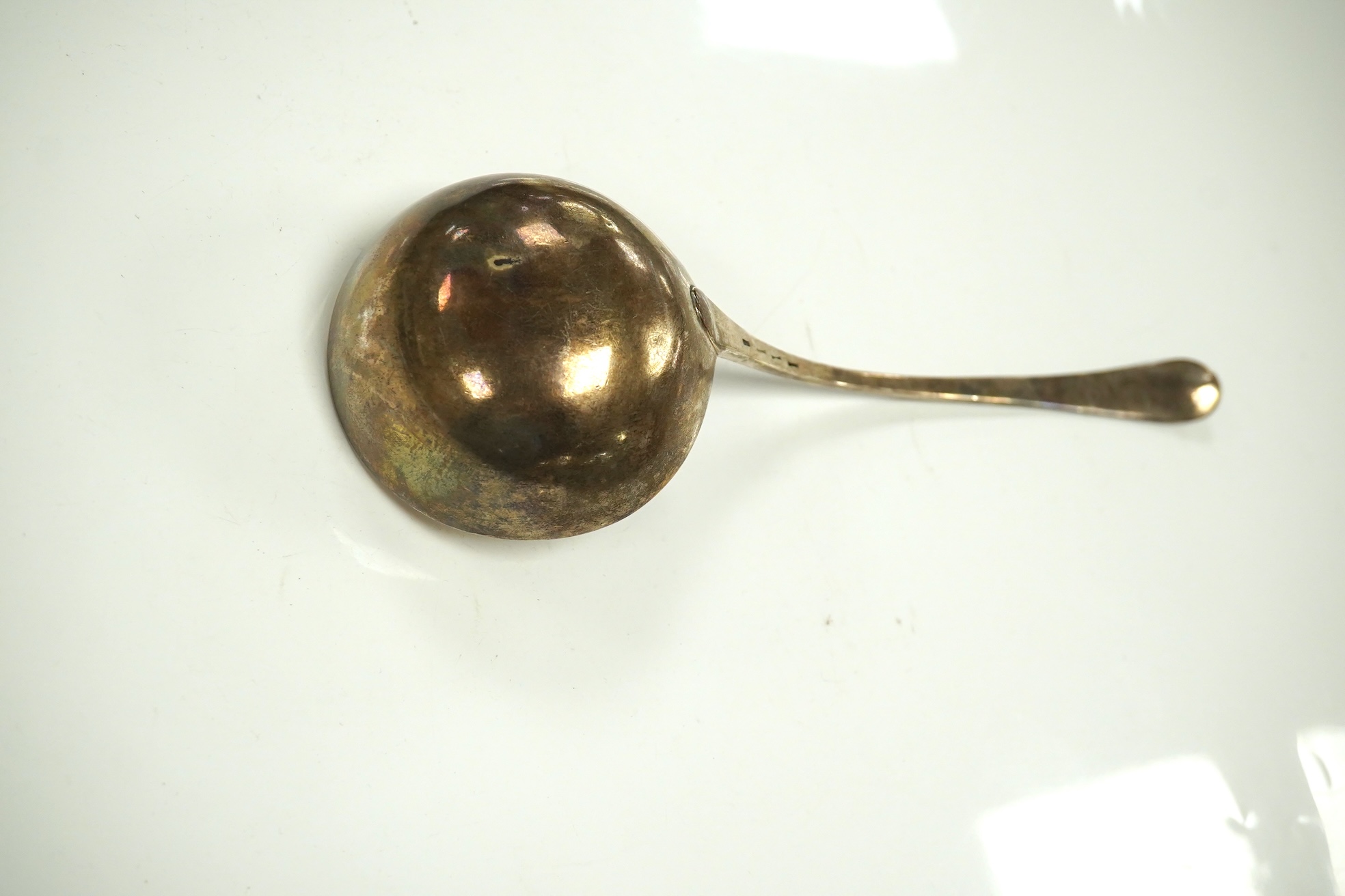 An 18ct century silver Old English pattern soup ladle, pinched marks, 32.8cm, 4.5oz. Condition - poor to fair